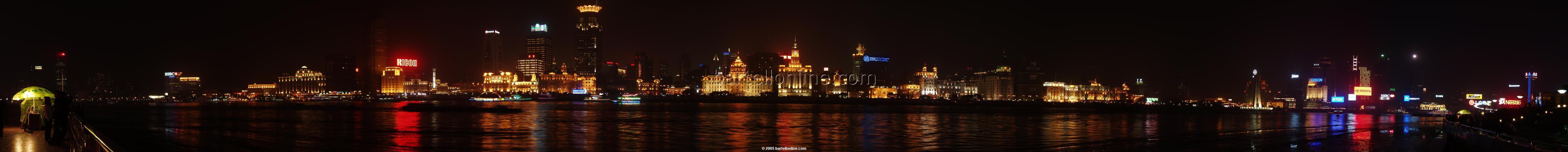 Night panorama of The Bund in Shanghai, China as seen from across the river in Pudong