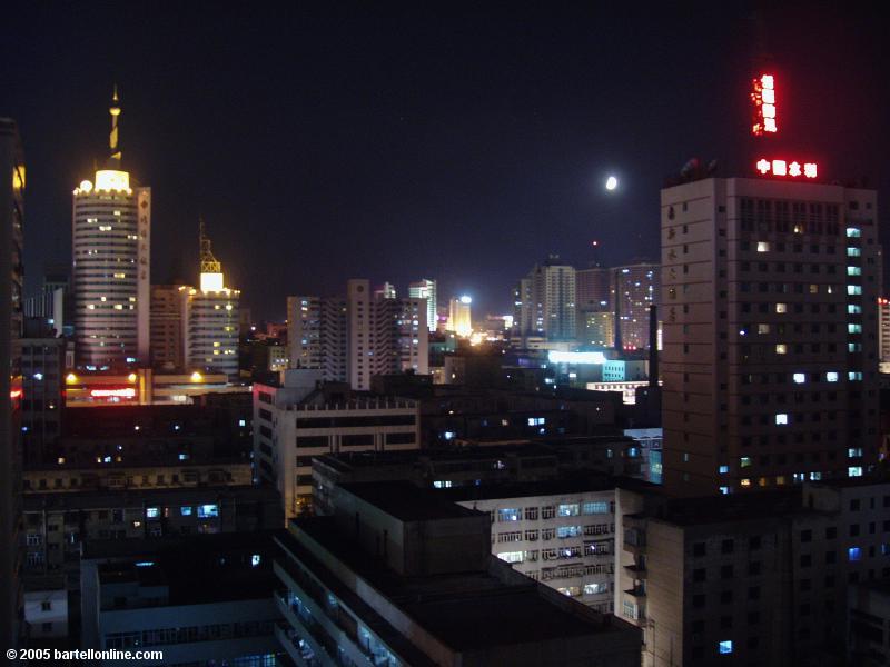 Night view of the moon over the city of Urumqi, Xinjiang, China
