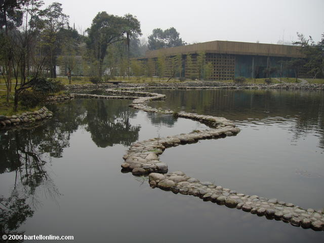 Stone pathway winds through a pond at Du Fu's Thatched Cottage in Chengdu, Sichuan, China