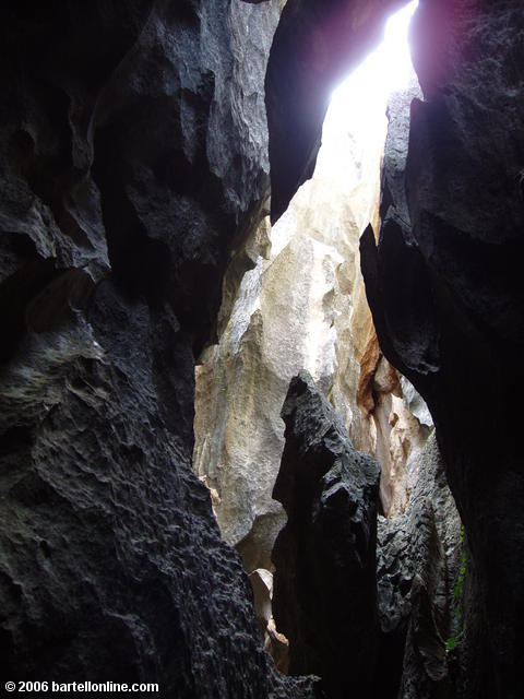The sun shines through a narrow crevasse at the Stone Forest near Kunming, Yunnan, China