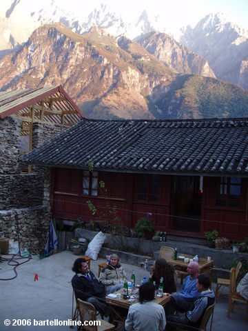 Backpackers enjoy food, drink, and conversation in the courtyard of the Tea Horse Guesthouse along Tiger Leaping Gorge in Yunnan, China