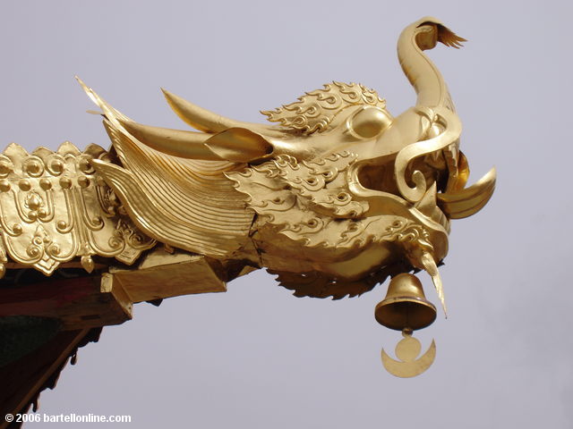 Detail of golden dragon head decorating a building in the Songzanlin Monastery near Zhongdian ("Shangri-La"), Yunnan, China