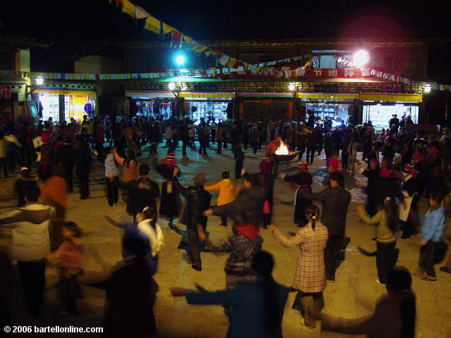 People dancing in the evening in a square in the old town section of Zhongdian ("Shangri-La"), Yunnan, China