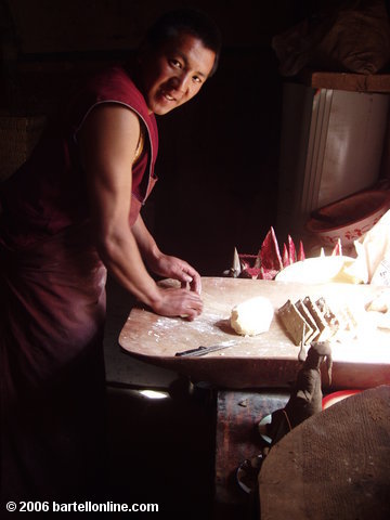 Buddhist monk prepares food in the Songzanlin Monastery near Zhongdian ("Shangri-La"), Yunnan, China